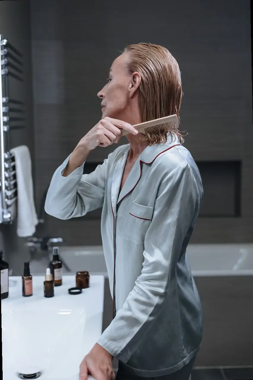 person preparing to use hair loss treatment