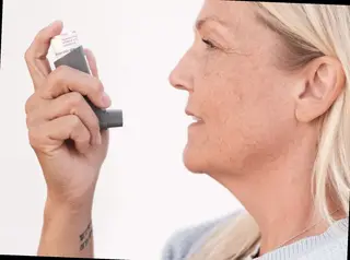 person using asthma inhaler at home